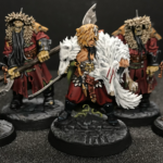 Radukar the Wolf leads his two Kosargi Nightguard amid two crow topped mysterious objects