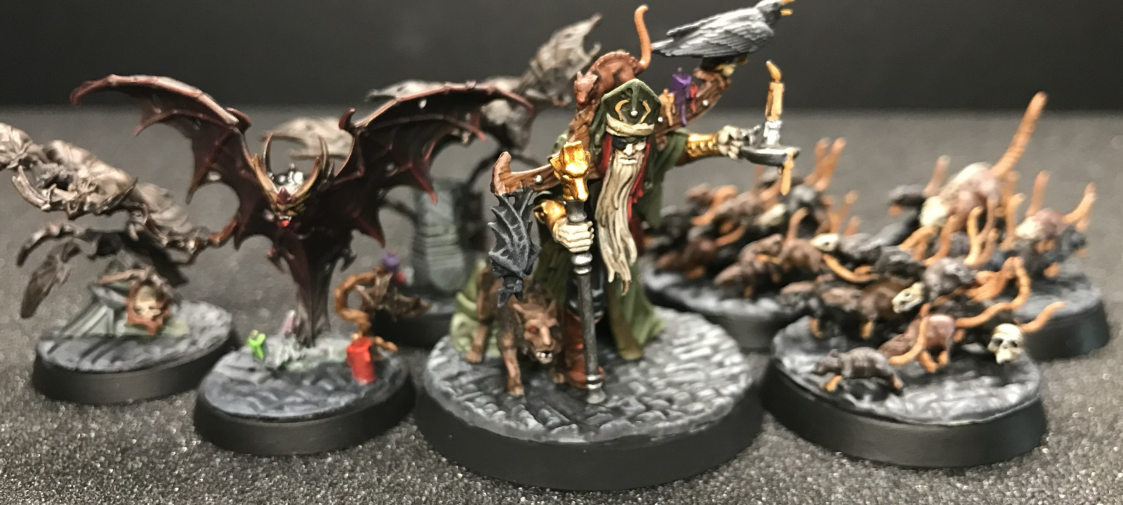 Torgillius the Chamberlain leads his bats and rats on green stuff modeled cobblestone bases.