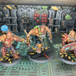 Three Goliath champions, each sporting hazard stripes.