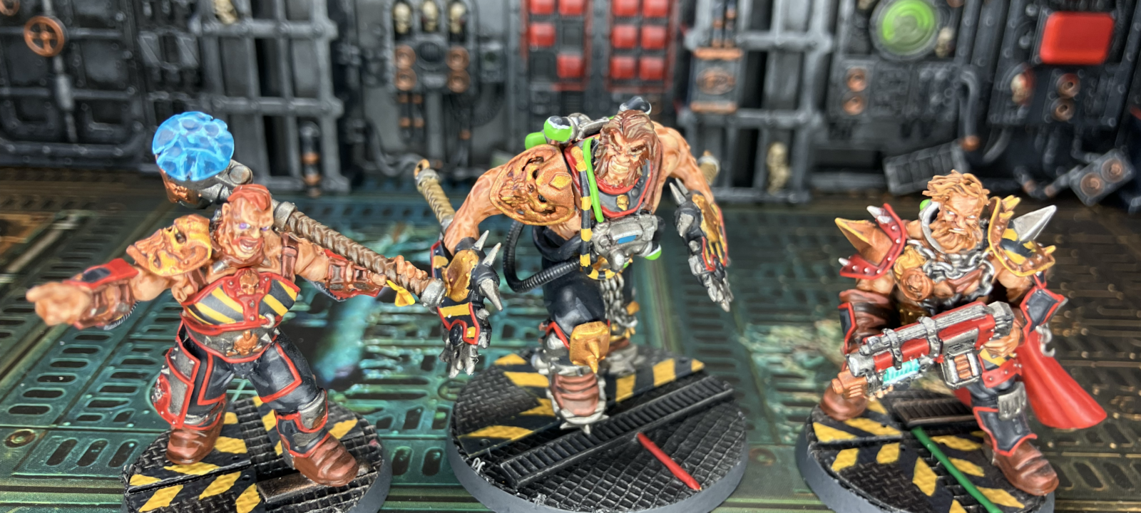 Three Goliath champions, each sporting hazard stripes.