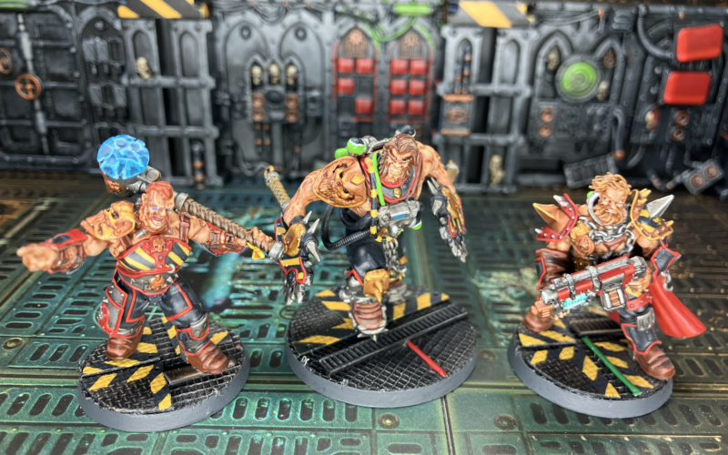 Three Goliath champions, each sporting hazard stripes.