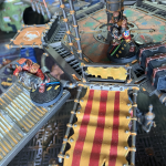 Two gangers stand on a platform in the underhive.