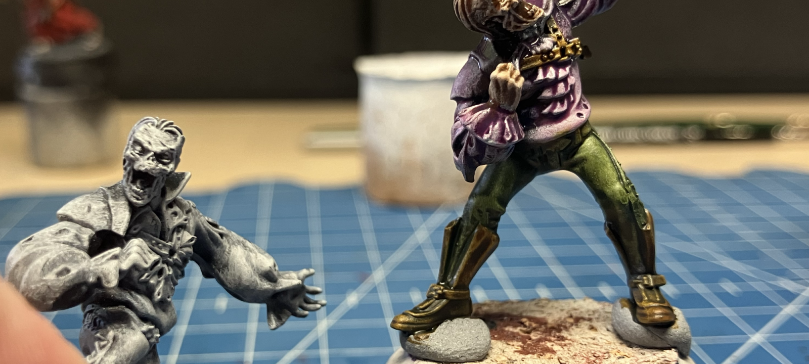 Two zombie conversions being painted in the slap chop style