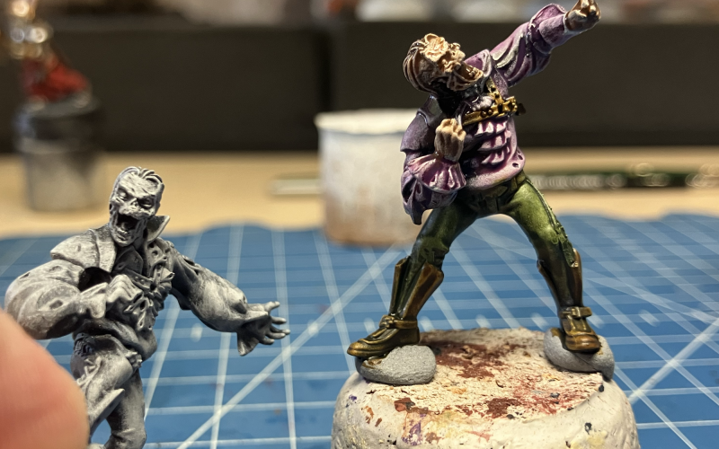 Two zombie conversions being painted in the slap chop style