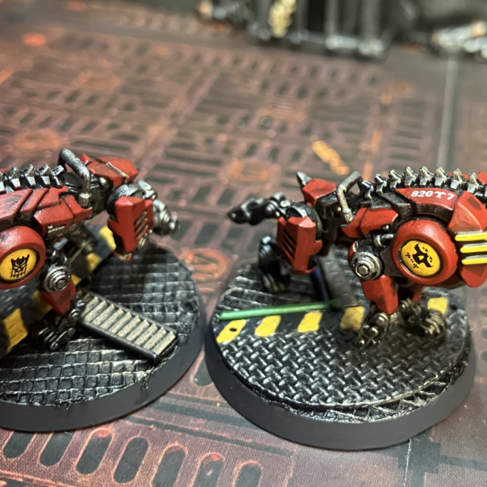 Two cyber-mastiffs with logos on their shoulders and serial number decals.