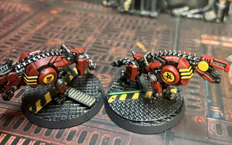 Two cyber-mastiffs with logos on their shoulders and serial number decals.