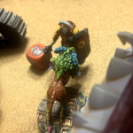 An Escher Grinx inflicts a murder dice against an Enforcer champion.