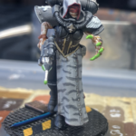 A painted kitbashed death maiden with off-white vestments and gray tiger stripes.