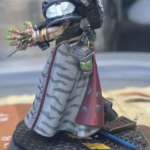 A painted kitbashed death maiden with off-white vestments and gray tiger stripes.
