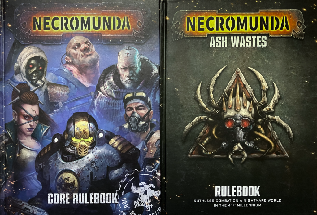 The Ash Wastes rulebook and the 2023 Core Rulebook.