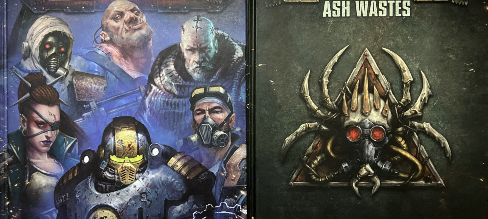 The Ash Wastes rulebook and the 2023 Core Rulebook.