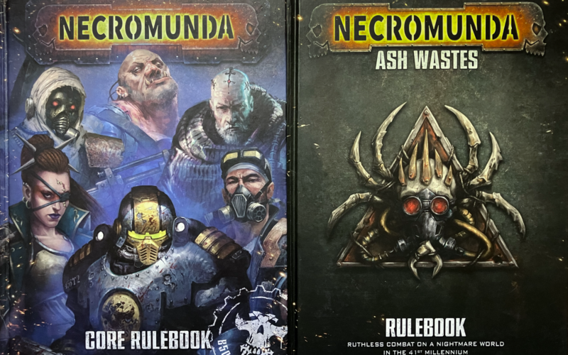 The Ash Wastes rulebook and the 2023 Core Rulebook.
