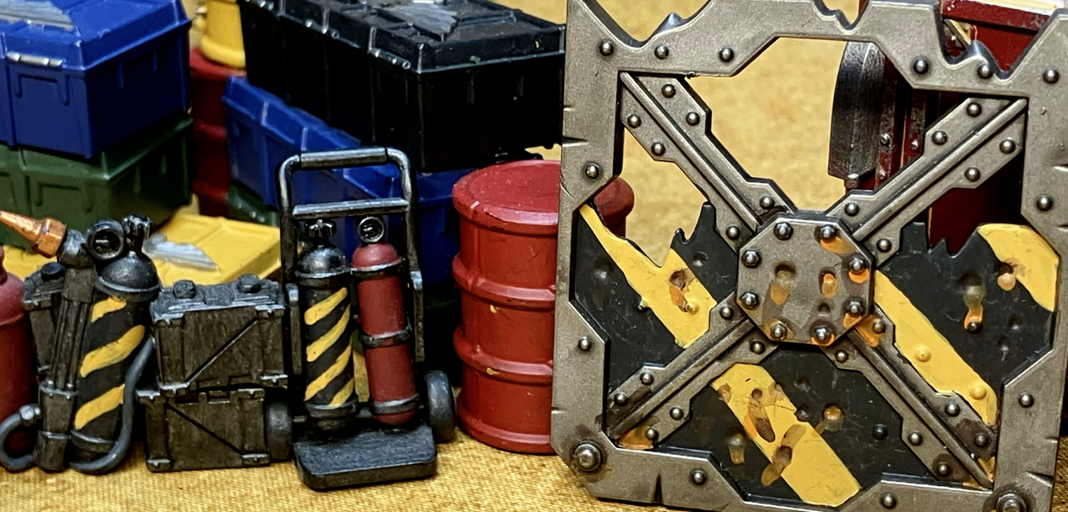 A barricade, repair kit, and barrel with hazard stripes.