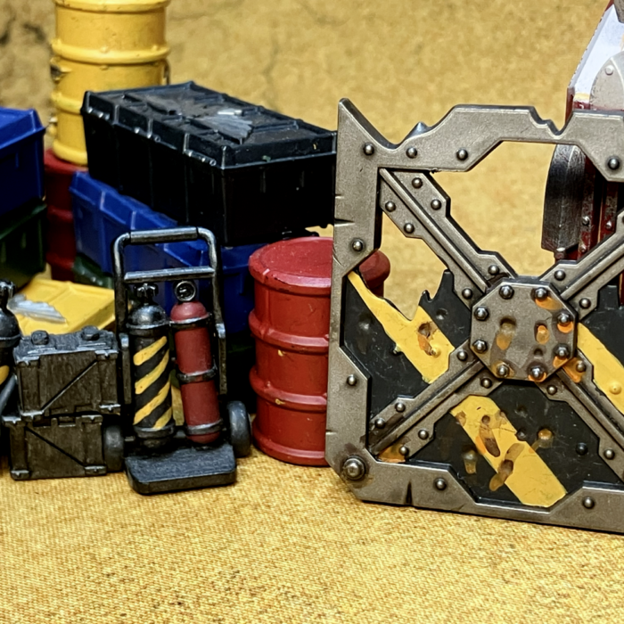 A barricade, repair kit, and barrel with hazard stripes.