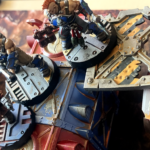 Two Goliath fighters and a hive scummer are set up for a battle.