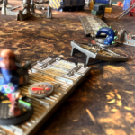 An outcast hive scummer runs across a platform over the sump sea with a tentacle in the way!