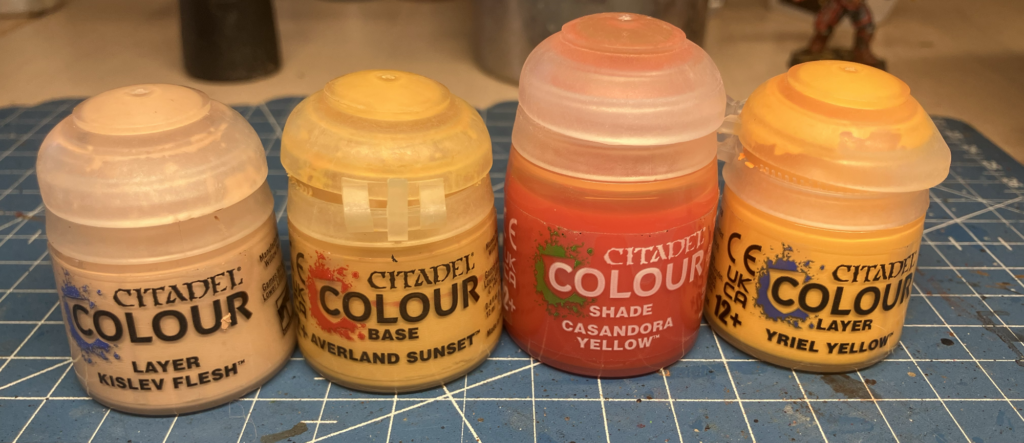 Three paints and a wash used for painting blonde hair