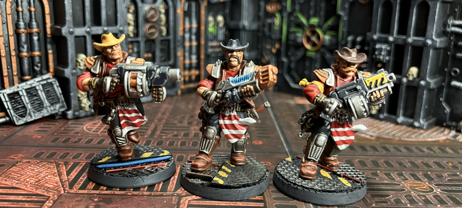 Three Orlock champions, one with a grenade launcher, one with a plasma gun, one with a bolter