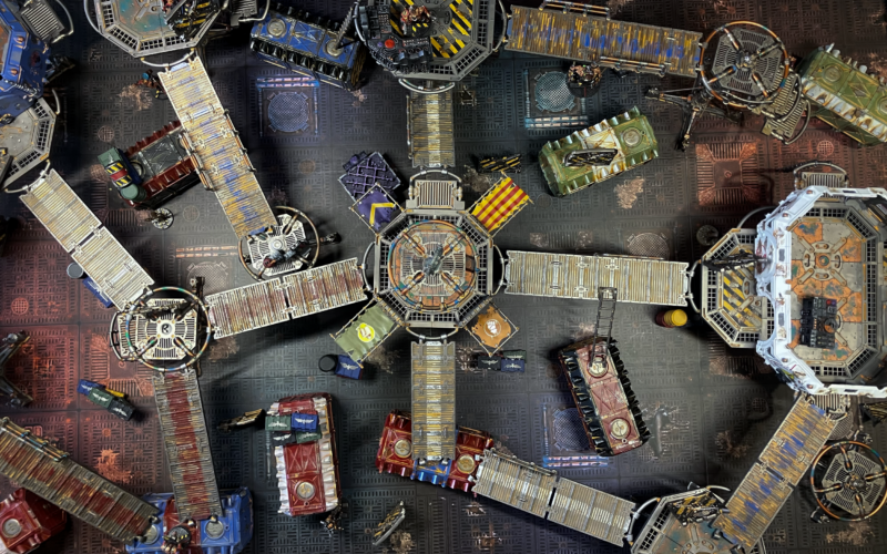 An underhive battlefield with a scenario generated from N26 cards.