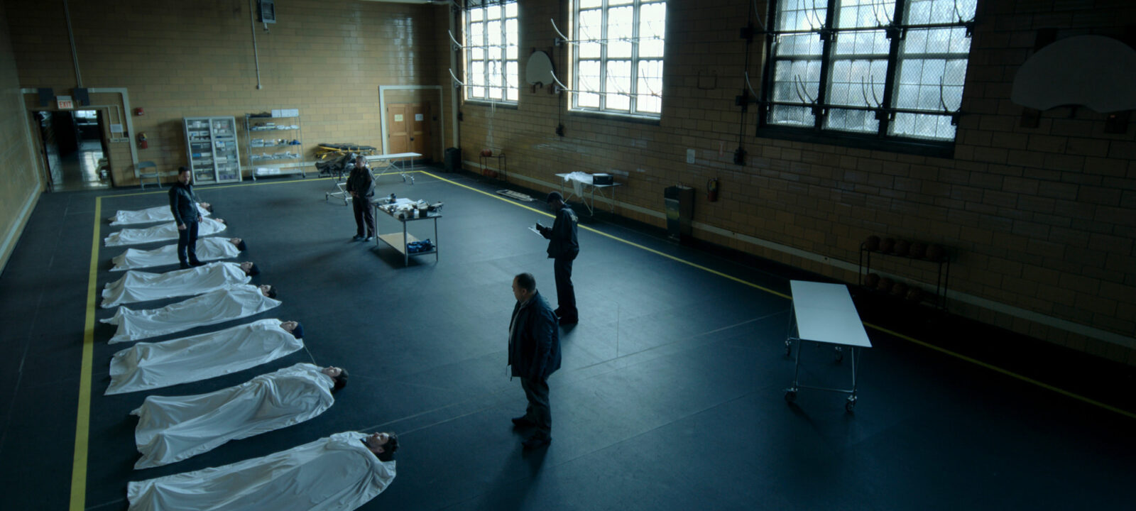 A still from Dark Matter, a line of bodies on the floor, all of them Jason or, at least, a version of Jason