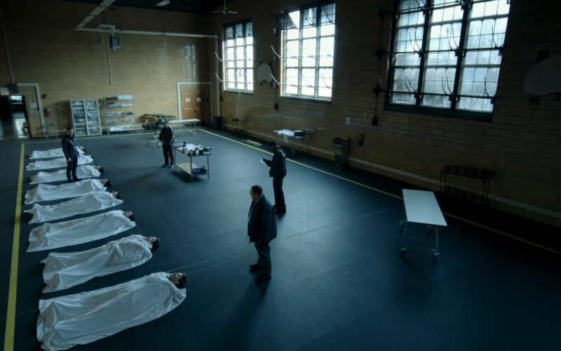 A still from Dark Matter, a line of bodies on the floor, all of them Jason or, at least, a version of Jason