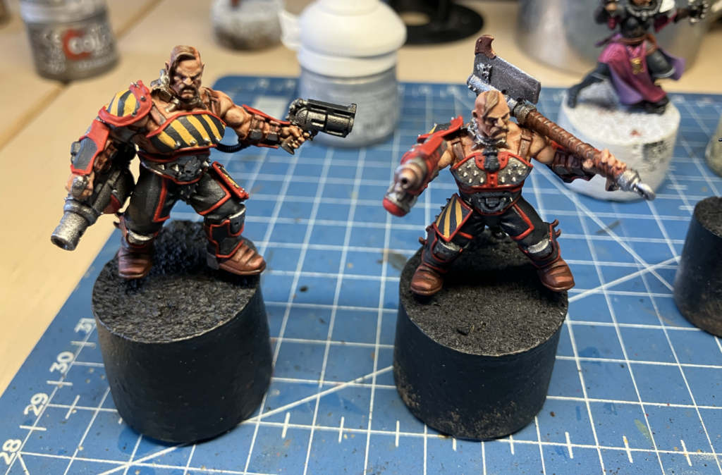 Two Goliath gangers, armed with a cleaver and flamer and a grenade launcher and stub gun