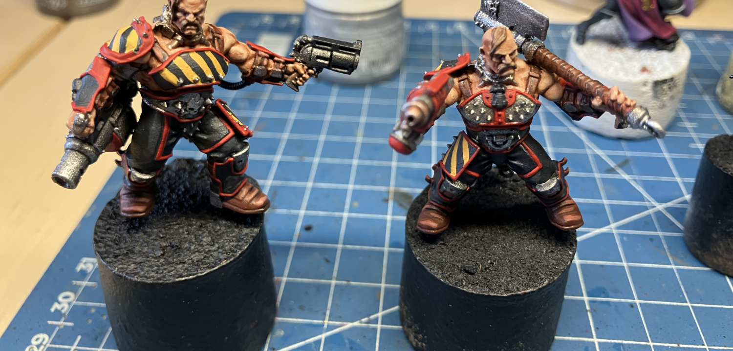 Two Goliath gangers, armed with a cleaver and flamer and a grenade launcher and stub gun